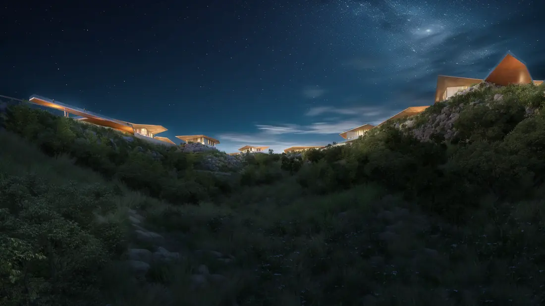 Community lit at night on the hillside
